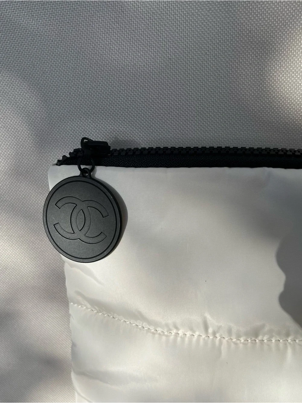 CHANEL White Quilted Cosmetic Pouch with Black Logo